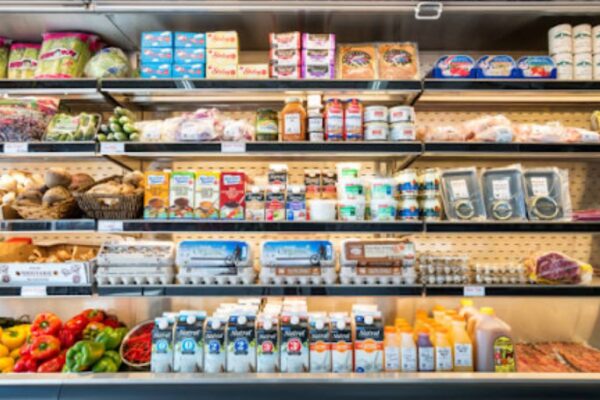 The Ultimate Guide to Choosing a Standard Restaurant Supply Store for Top-Quality Restaurant Appliances chef analyzing stainless double-door fridge from a widespread restaurant supply shop